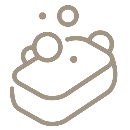 An outline style icon depicting a bar of soap with bubbles on top and above it